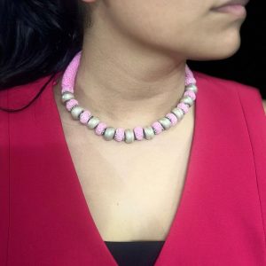 Silver balls in pink thread